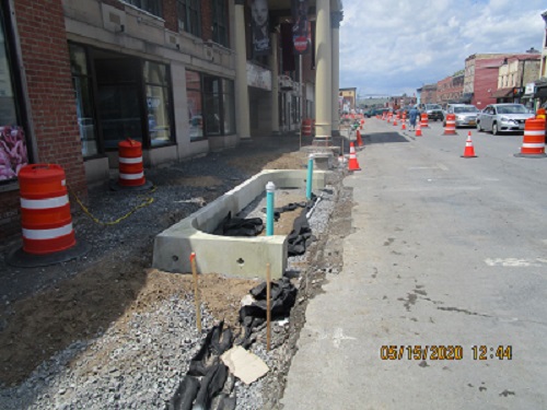 A bioswale being installed in front of UPAC. Trees and shrubs will occupy the bioswale.